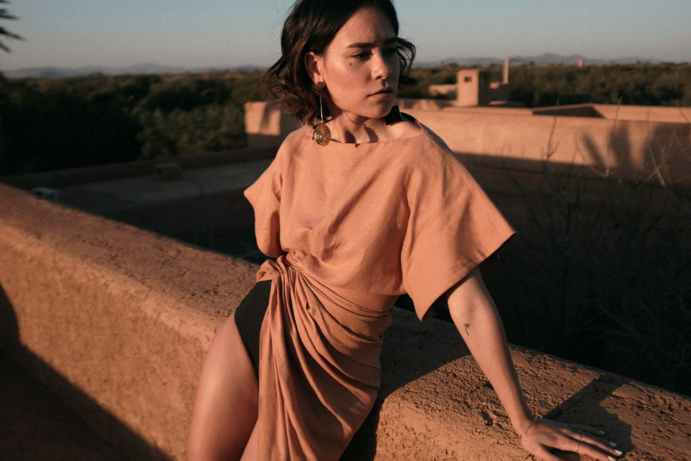 Nisi is wearing: Jacquemus La Robe Salvador dress and Le Carre earrings, The Row Chocolate Sandals in Morocco