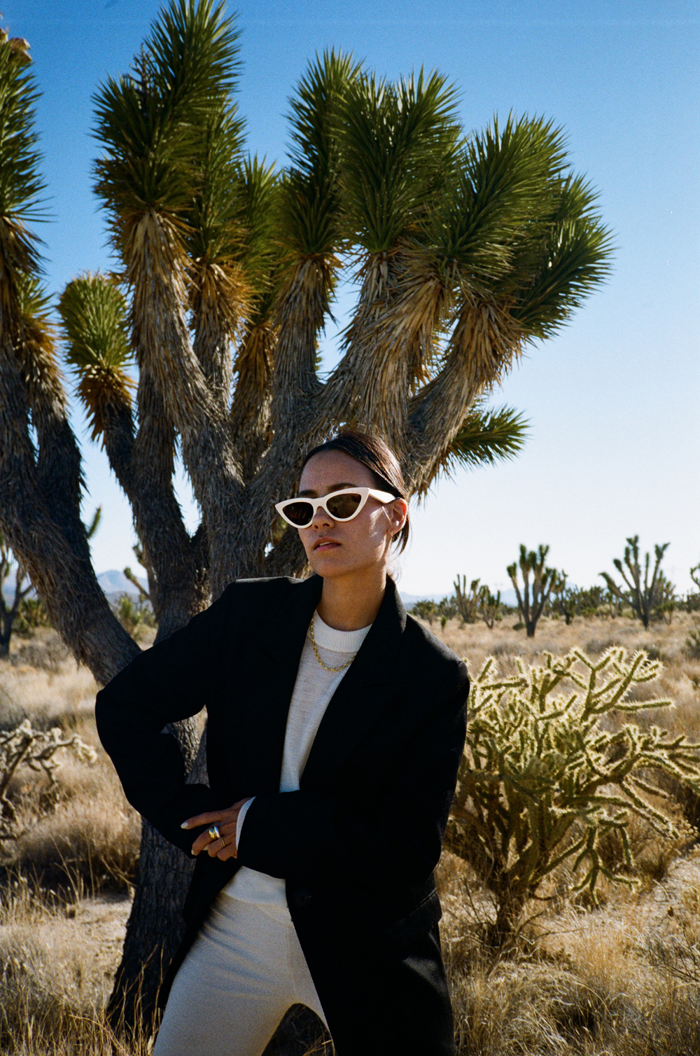 Shooting in Majove National Preserve. Wearing: Céline white sunglasses, Black blazer, cycling pants, Bottega Veneta small Basket bag