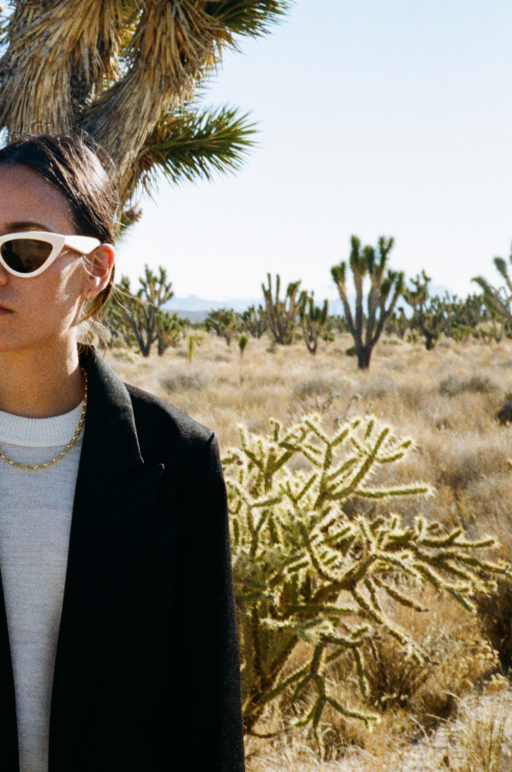 Shooting in Majove National Preserve. Wearing: Céline white sunglasses, Black blazer, cycling pants, Bottega Veneta small Basket bag