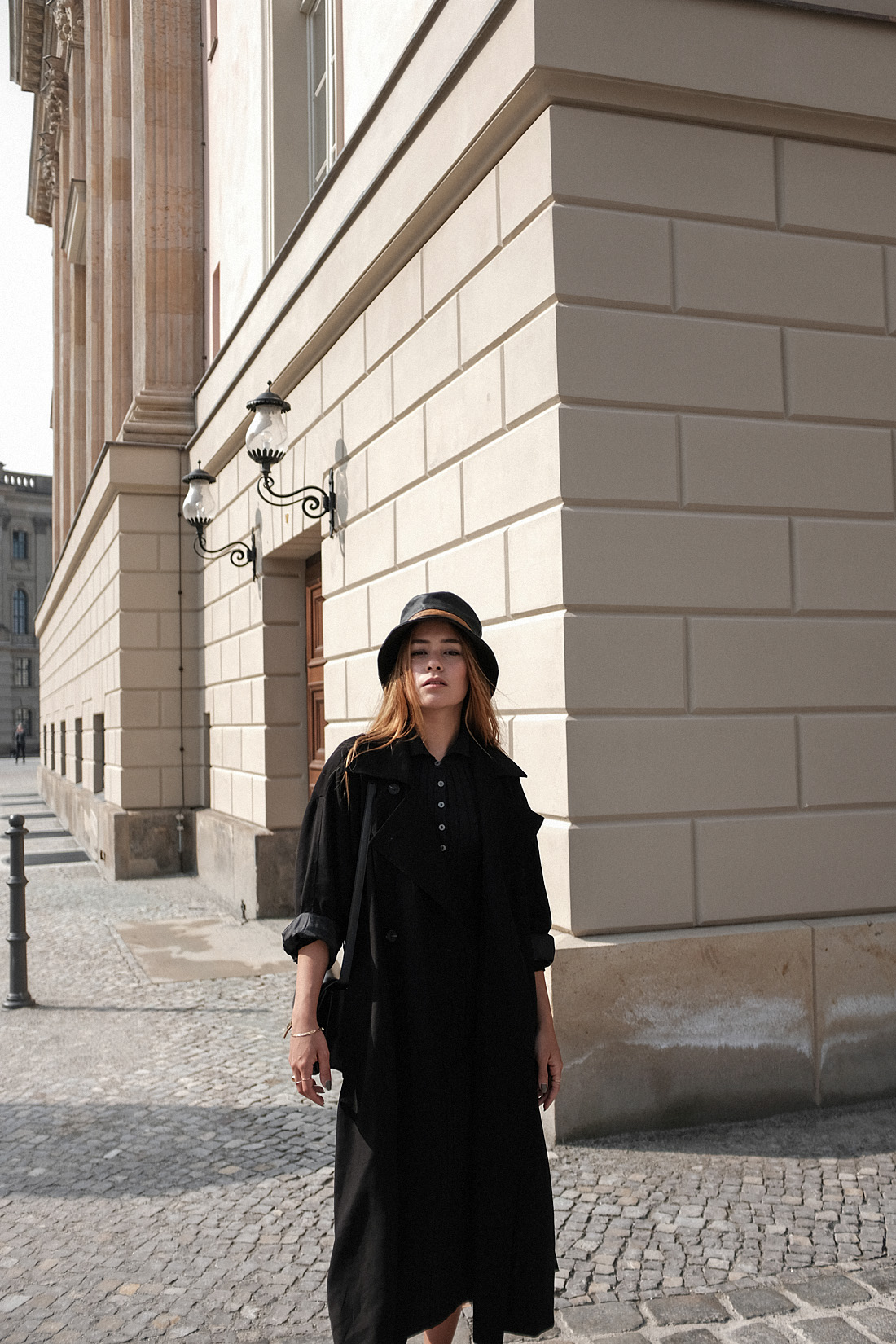 Desi is wearing a vintage Dior leather bucket hat, Edited the Label dress, Loewe loafers, Céline classic box bag, Tench coat from Seoul