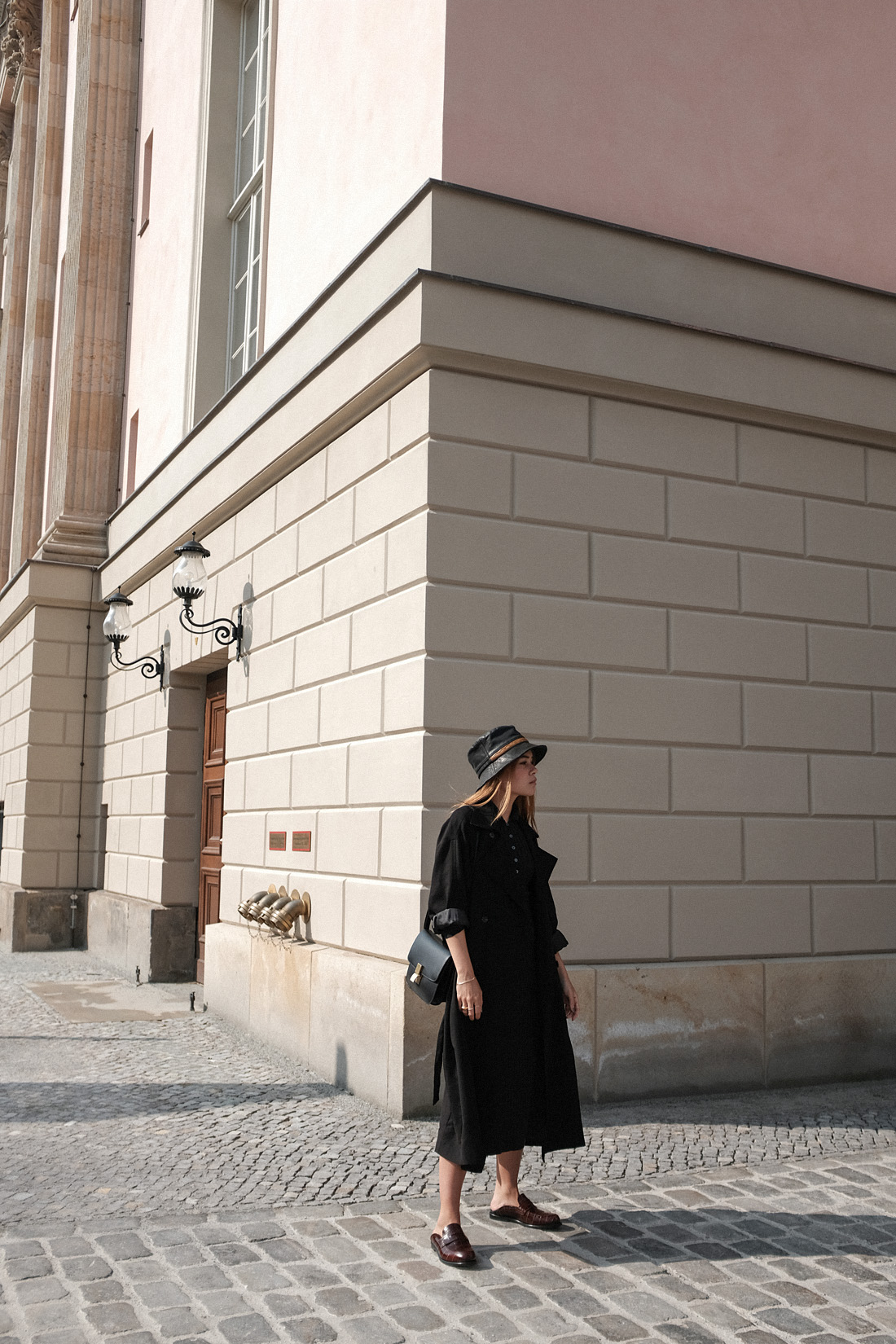 Desi is wearing a vintage Dior leather bucket hat, Edited the Label dress, Loewe loafers, Céline classic box bag, Tench coat from Seoul