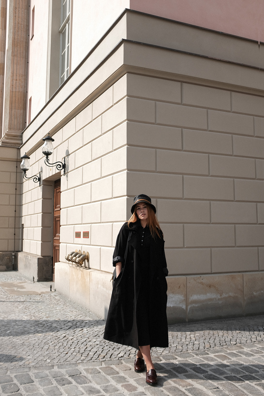 Desi is wearing a vintage Dior leather bucket hat, Edited the Label dress, Loewe loafers, Céline classic box bag, Tench coat from Seoul