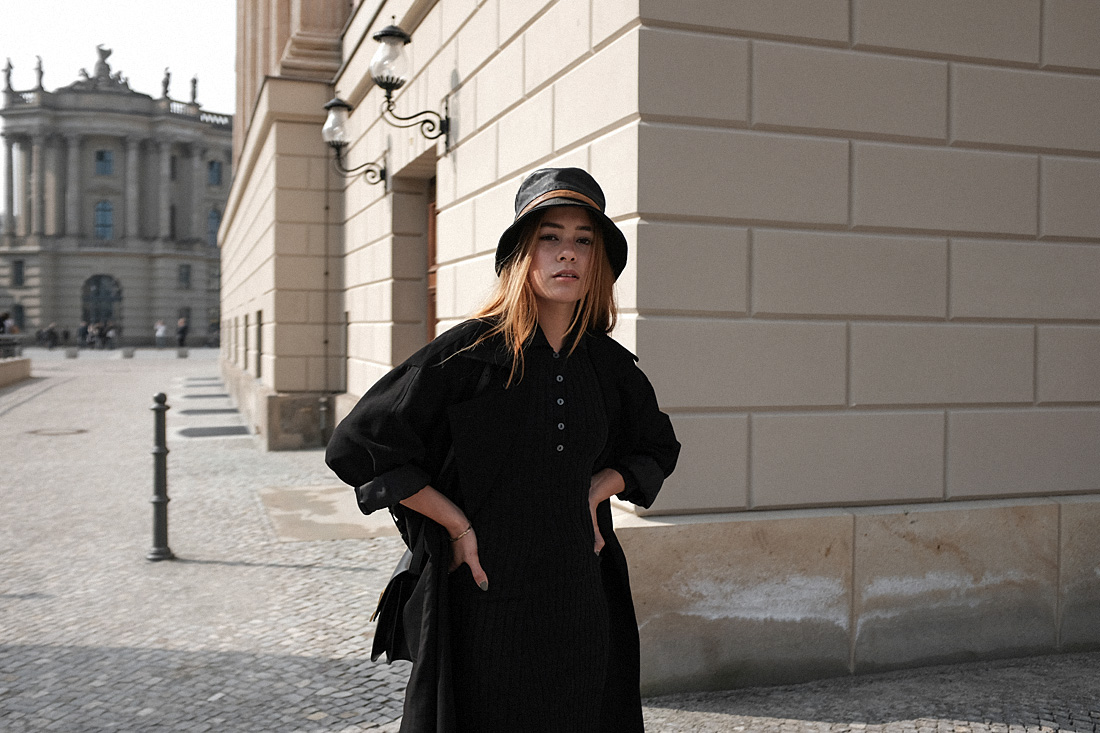 Desi is wearing a vintage Dior leather bucket hat, Edited the Label dress, Loewe loafers, Céline classic box bag, Tench coat from Seoul