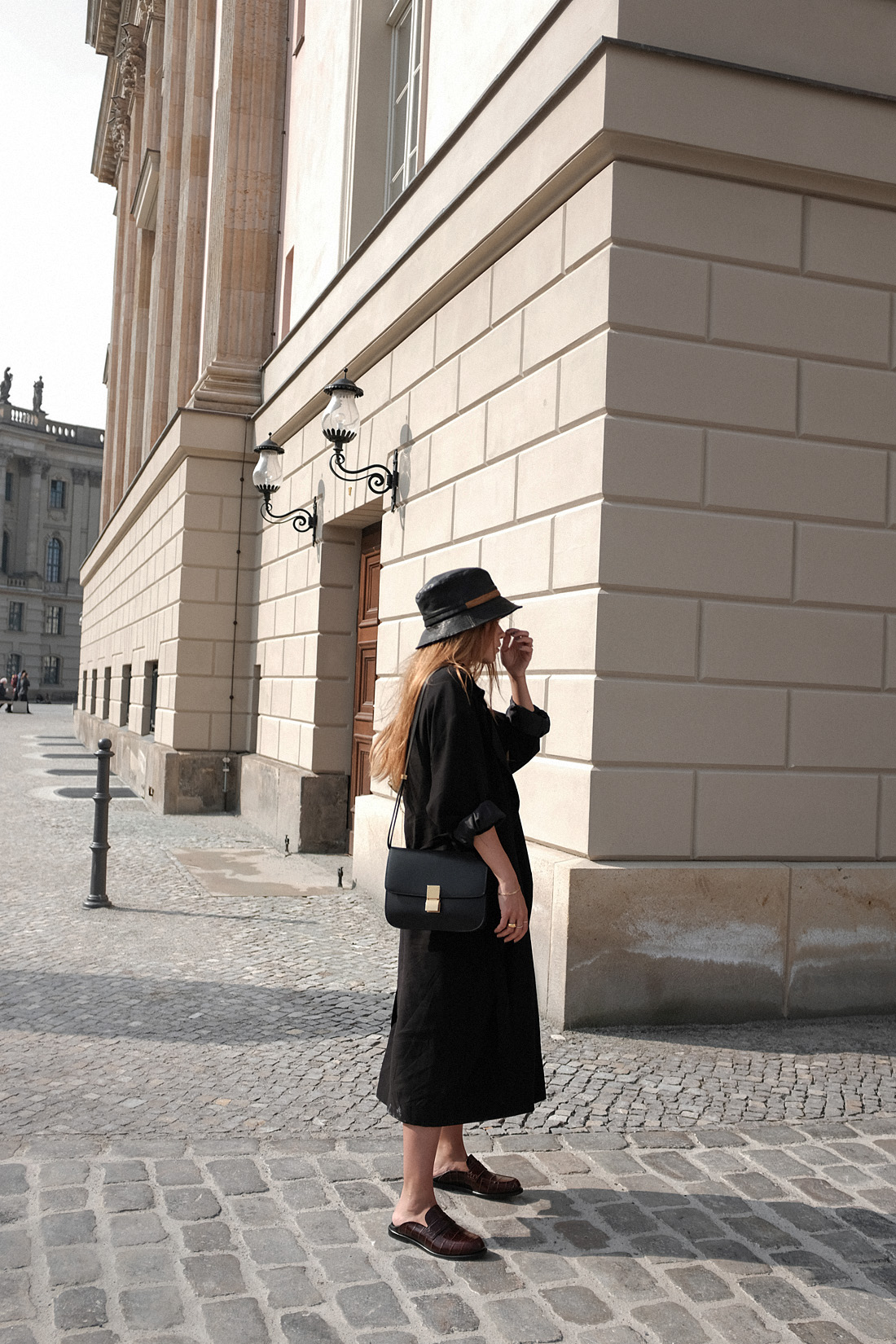 Desi is wearing a vintage Dior leather bucket hat, Edited the Label dress, Loewe loafers, Céline classic box bag, Tench coat from Seoul