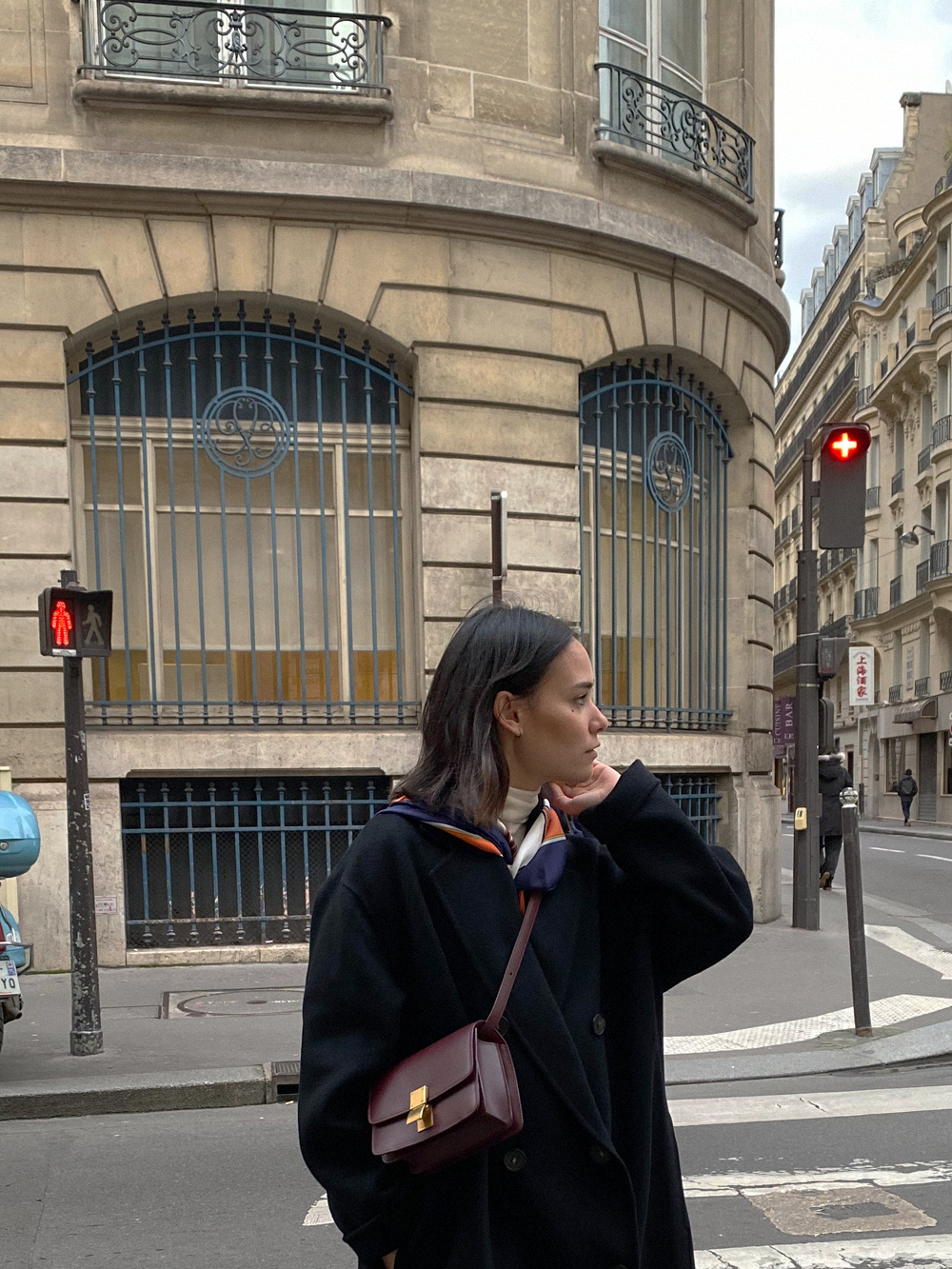 Spring Outfit. Nisi is wearing: Black wool coat ACNE STUDIOS, Beige denim jeans ZARA, Classic Box bag in bordeaux CÉLINE, Maysale mules MANOLO BLAHNIK, Vintage silk scarf HERMÈS