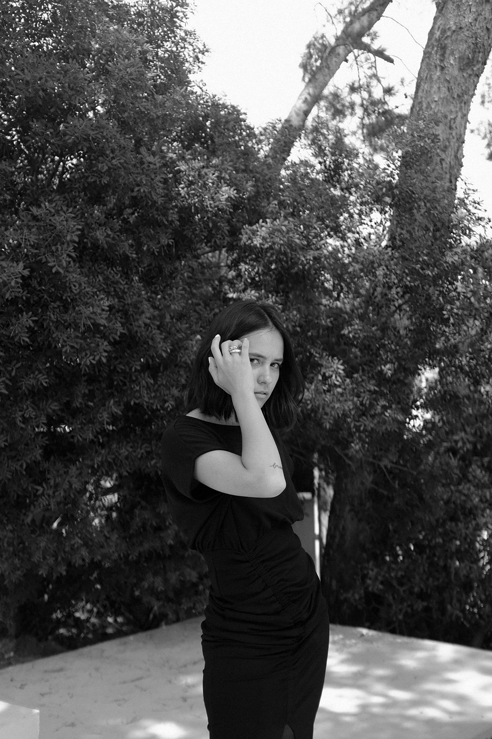 Nisi is wearing: Bottega Veneta Clogs Sandals, black tube dress