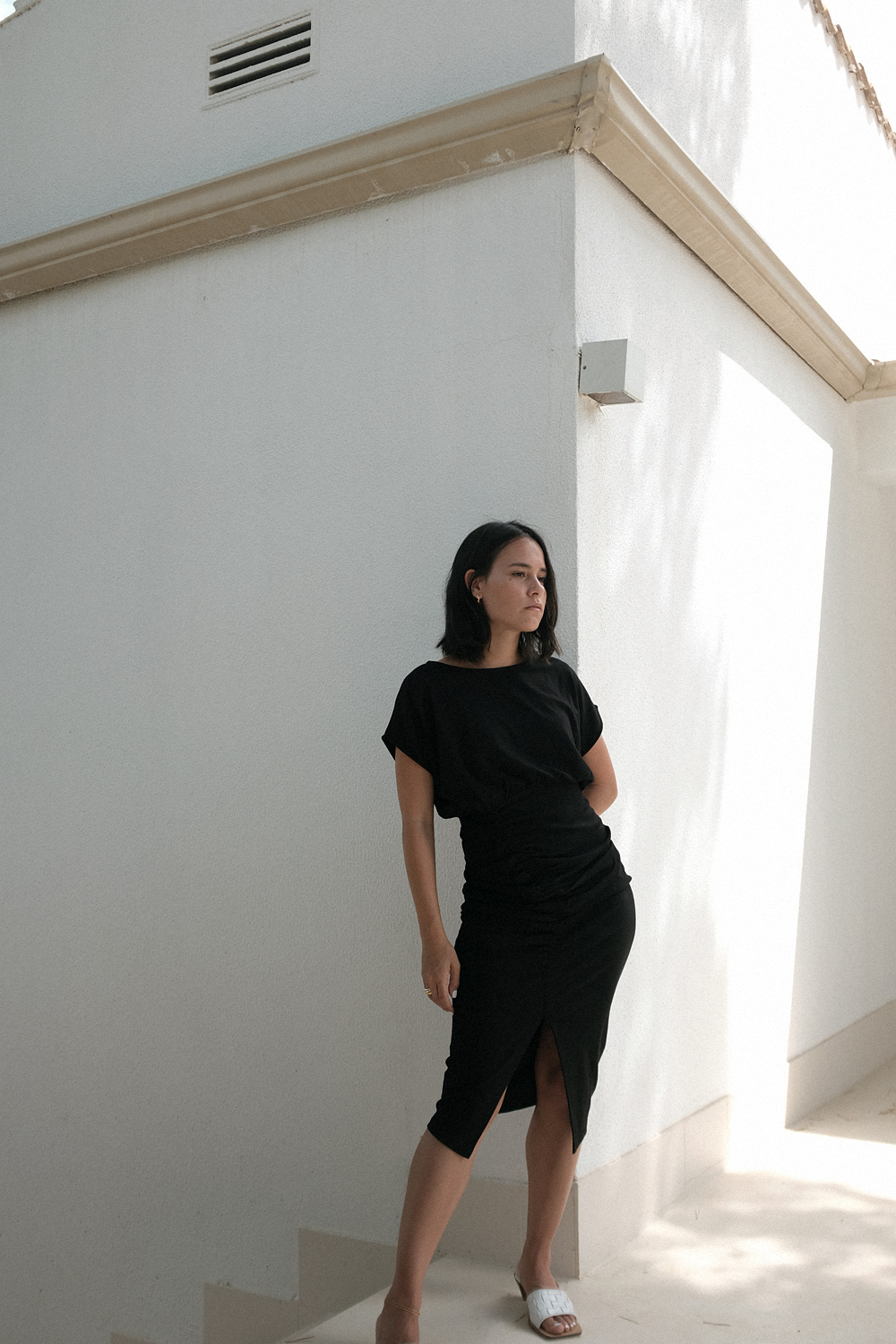 Nisi is wearing: Bottega Veneta Clogs Sandals, black tube dress