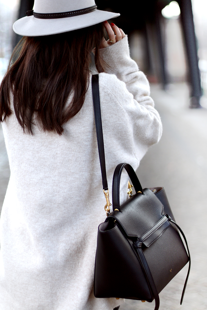 Nisi is wearing: Céline Belt Bag, Fedora Hat, Distressd Denim, Ripped Jeans, Chelsea Boots, Oversized Sweater