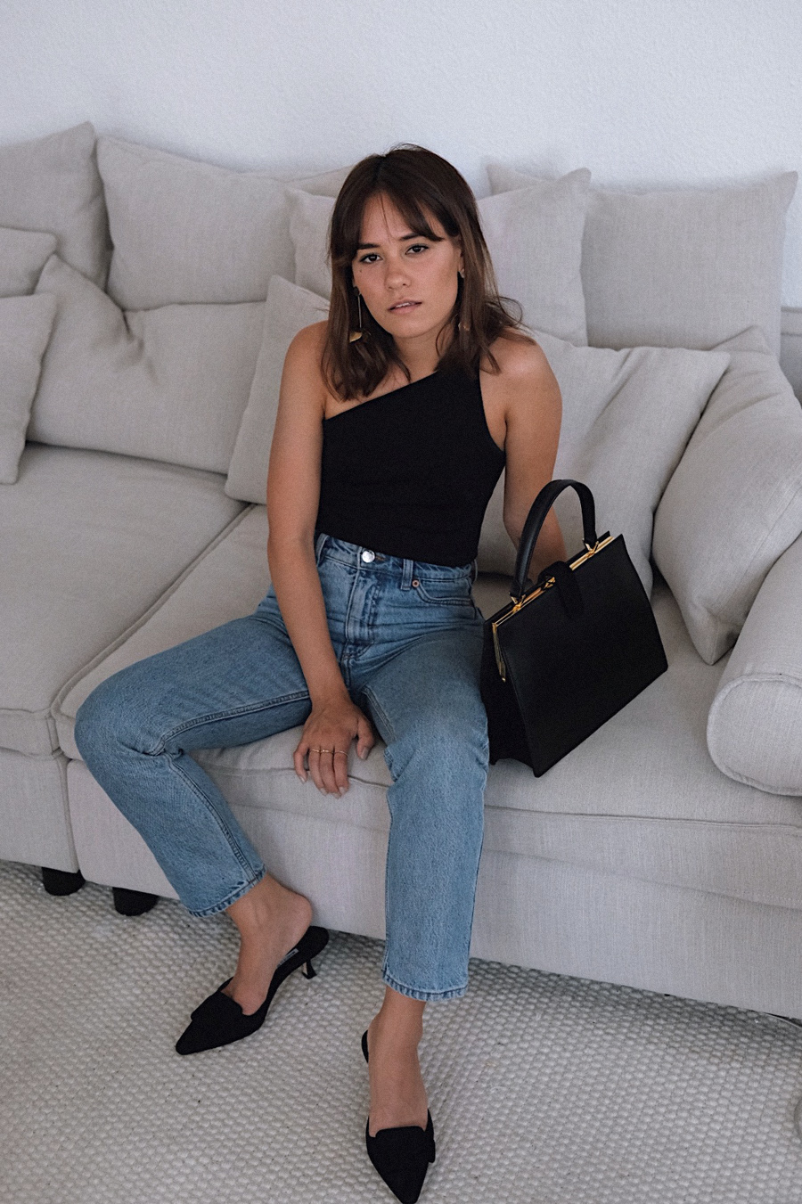 The best pair of denim jeans. Nisi is wearing: Monki Kimomo Jeans, Zara asymmetric body, Manolo Blahnik Maysale Mules, Clasp Bag