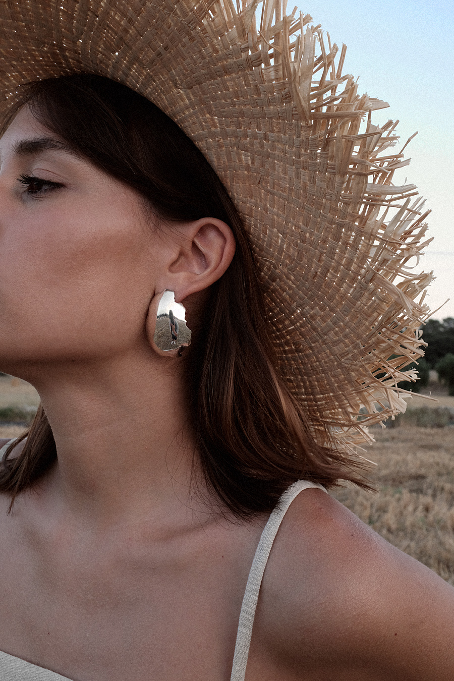 Monochrome looks on the fields of Majorca: white Jacquemus blouse, white palazzo trousers, ruffled linen dress, black bathing suit, white cropped pants, Jacquemus earrings, All Blues earrings, Brie Leon hoops, straw hats