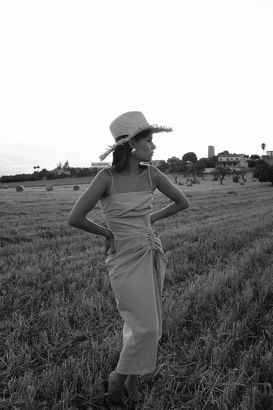 Monochrome looks on the fields of Majorca: white Jacquemus blouse, white palazzo trousers, ruffled linen dress, black bathing suit, white cropped pants, Jacquemus earrings, All Blues earrings, Brie Leon hoops, straw hats
