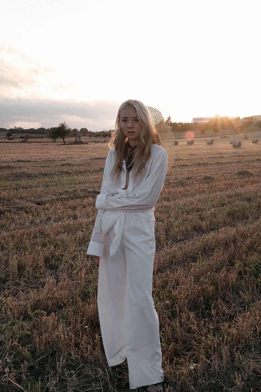 Monochrome looks on the fields of Majorca: white Jacquemus blouse, white palazzo trousers, ruffled linen dress, black bathing suit, white cropped pants, Jacquemus earrings, All Blues earrings, Brie Leon hoops, straw hats