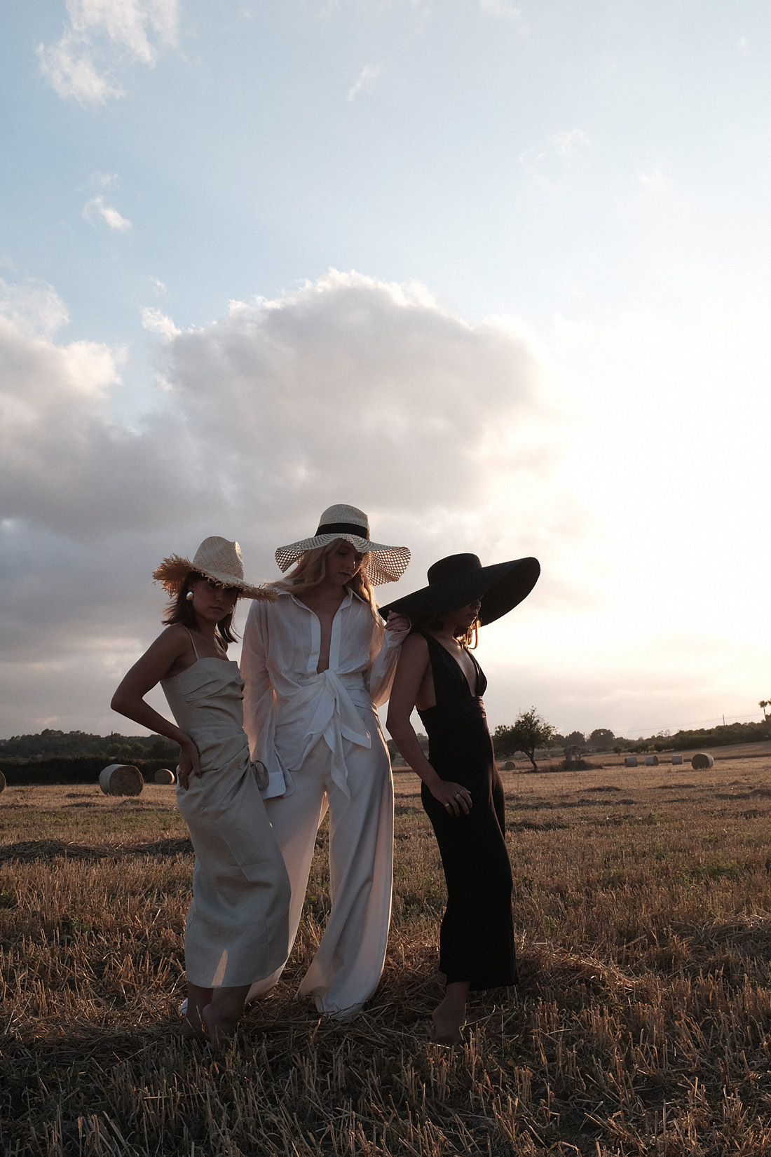 Monochrome looks on the fields of Majorca: white Jacquemus blouse, white palazzo trousers, ruffled linen dress, black bathing suit, white cropped pants, Jacquemus earrings, All Blues earrings, Brie Leon hoops, straw hats