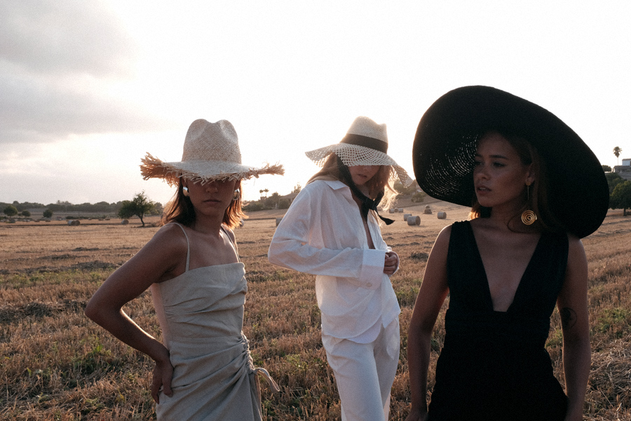 Monochrome looks on the fields of Majorca: white Jacquemus blouse, white palazzo trousers, ruffled linen dress, black bathing suit, white cropped pants, Jacquemus earrings, All Blues earrings, Brie Leon hoops, straw hats