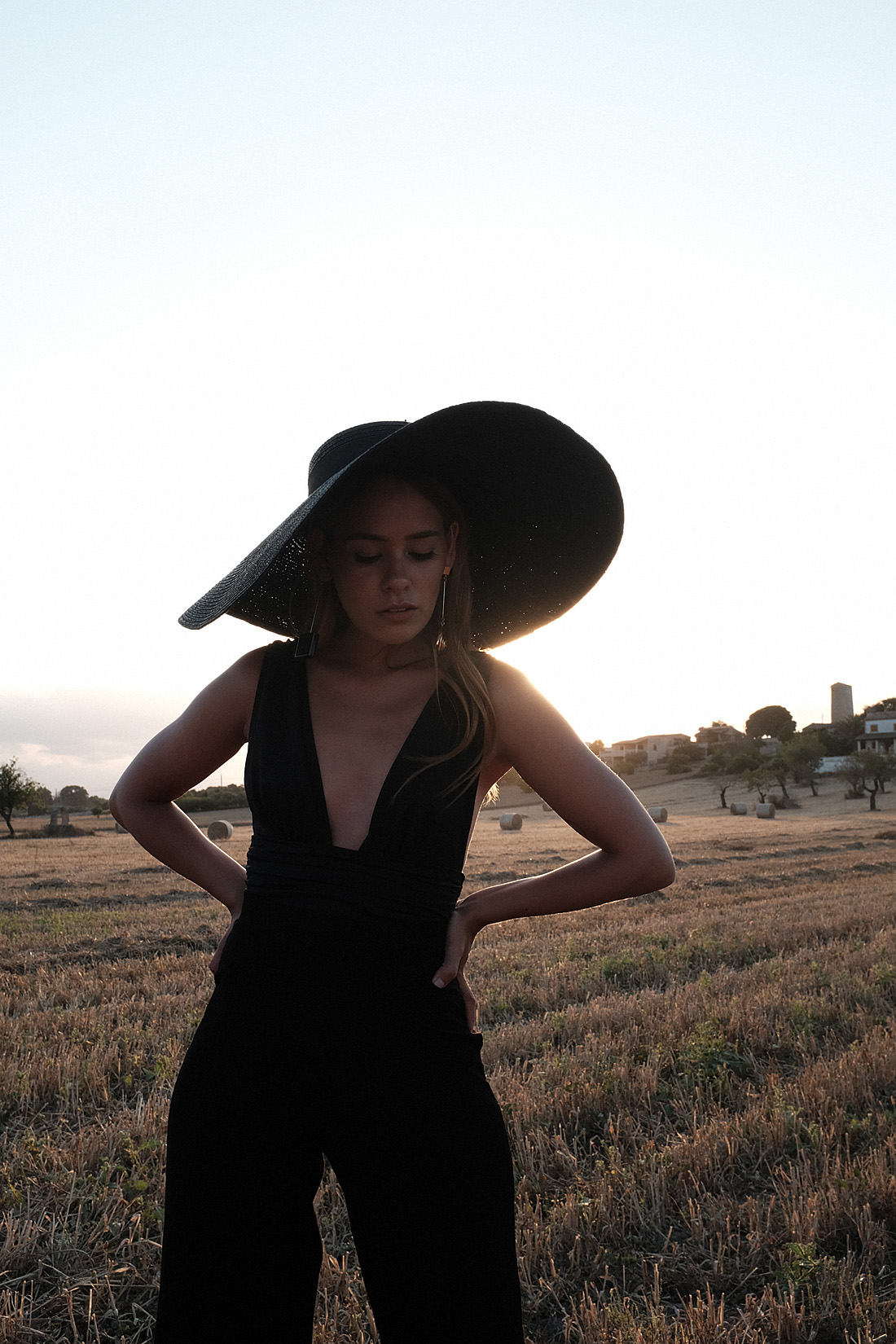 Monochrome looks on the fields of Majorca: white Jacquemus blouse, white palazzo trousers, ruffled linen dress, black bathing suit, white cropped pants, Jacquemus earrings, All Blues earrings, Brie Leon hoops, straw hats
