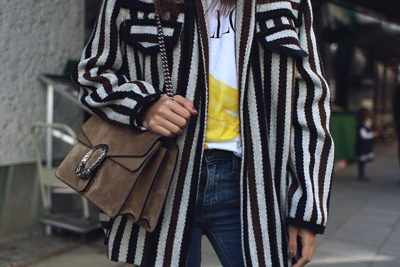 Nisi is wearing: Isabel Marant Étoile Breeda coat, Ganni murphy t-shirt, Levi's skinny jeans, Gucci Dionysus bag, Acne Studios jensen boots