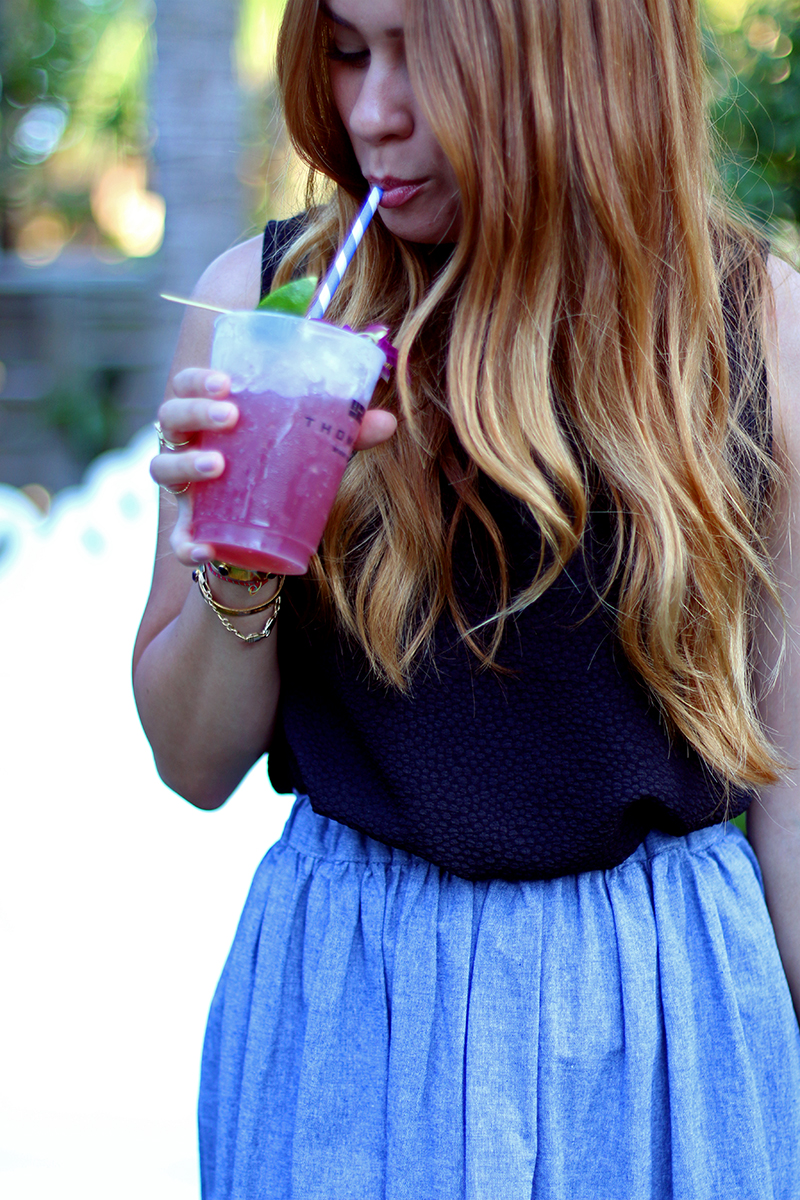 Desi is wearing a black top and grey midi skirt at the Urban Decay Summer Nights party in Miami
