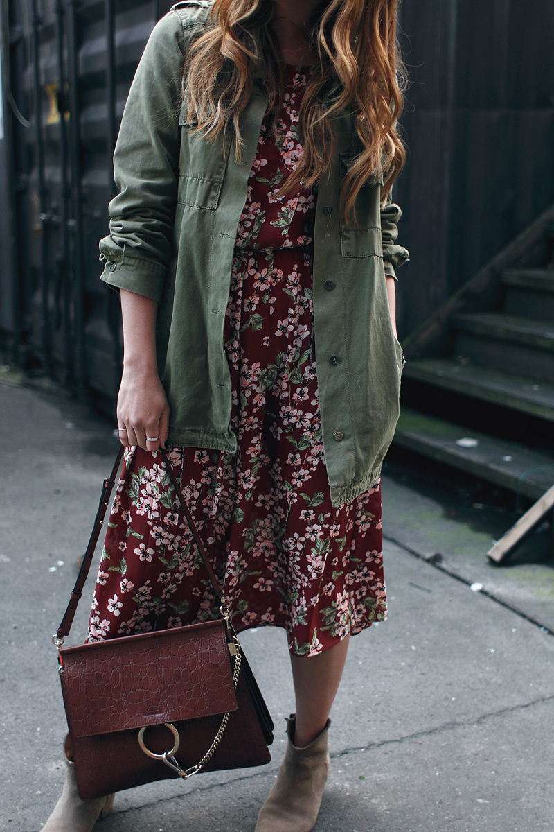 At the flower market. Desi is wearing: Chloé Faye Bag, Flower print dress, green parka jacket, Isabel Marant Dicker boots
