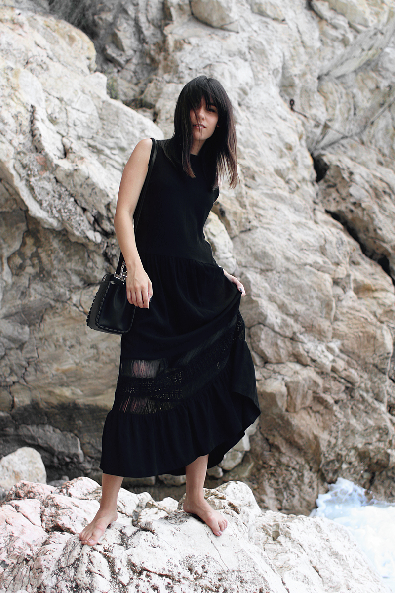 All Black Outfit in Sicily. Nisi is wearing: Midi dress – Sandro. Oran Sandals – Hermès. Mini Peekaboo Bag – Fendi
