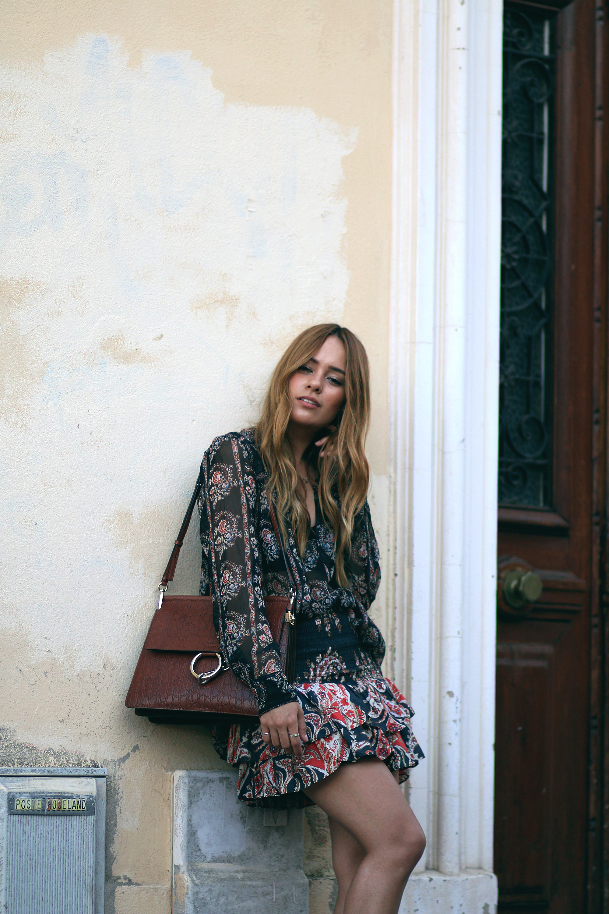Desi is wearing: Isabel Marant printed silk blouse, Isabel Marant ruffled paisley skirt, platform sandals, Chloé Faye bag in Cannes