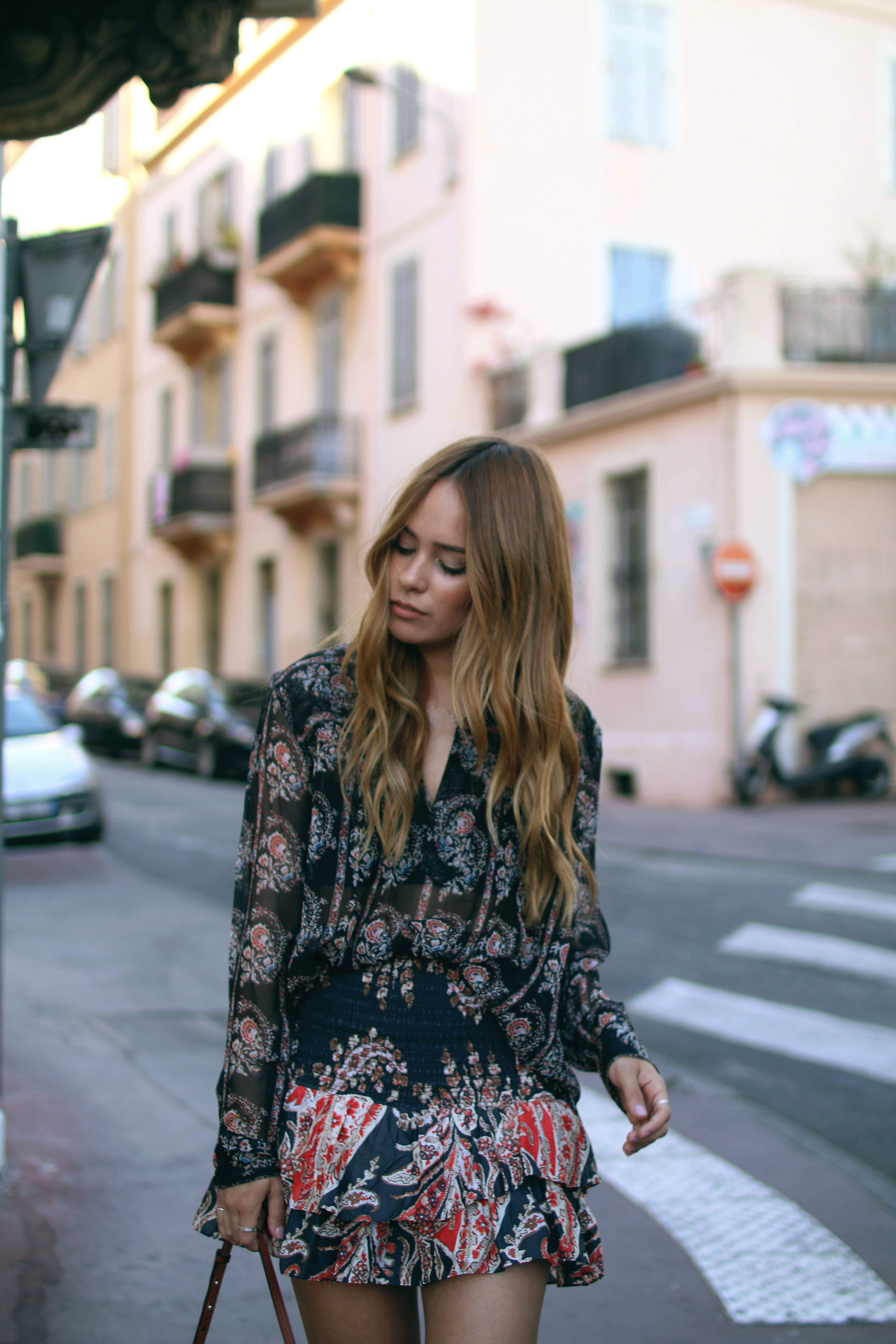 Desi is wearing: Isabel Marant printed silk blouse, Isabel Marant ruffled paisley skirt, platform sandals, Chloé Faye bag in Cannes