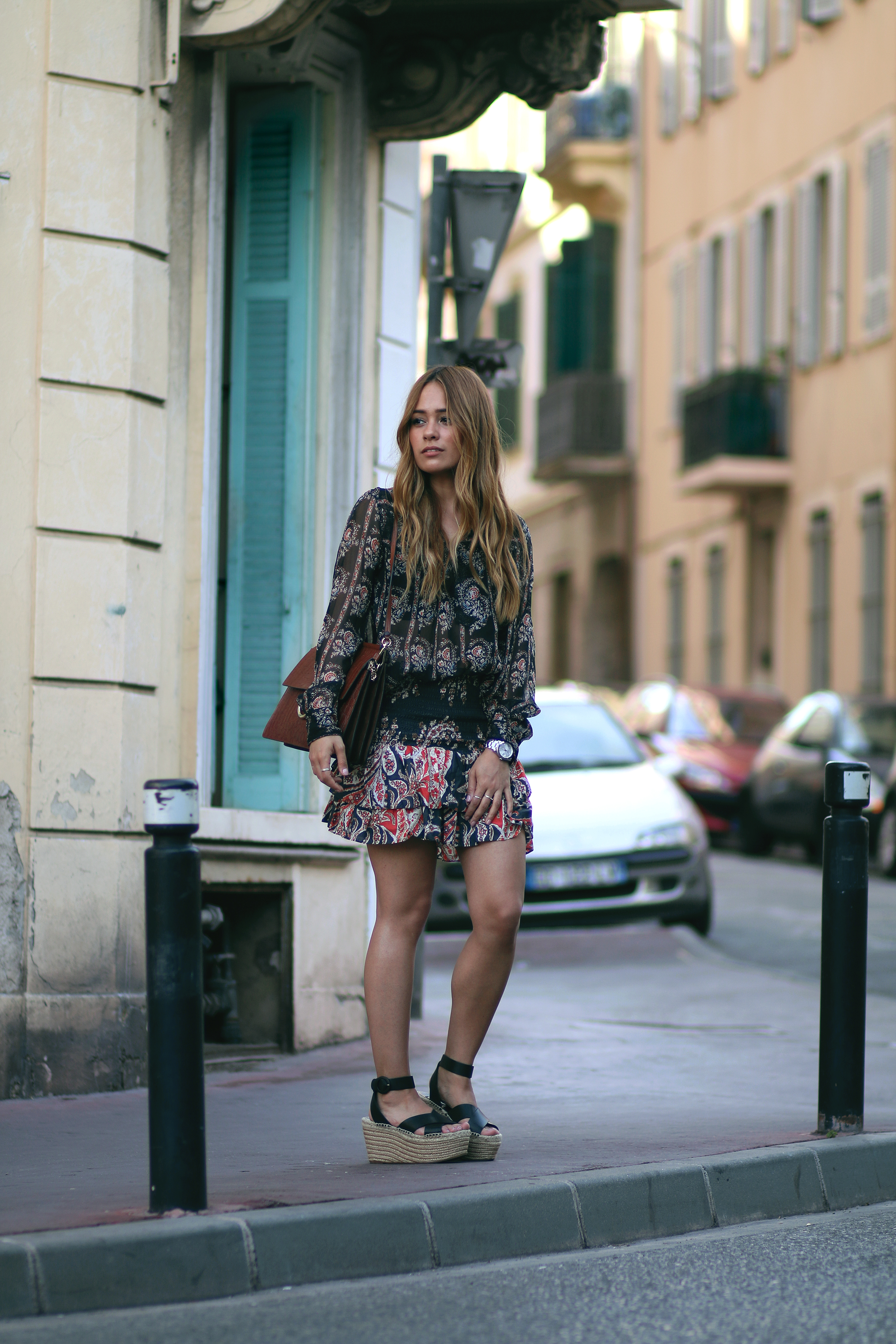 Desi is wearing: Isabel Marant printed silk blouse, Isabel Marant ruffled paisley skirt, platform sandals, Chloé Faye bag in Cannes