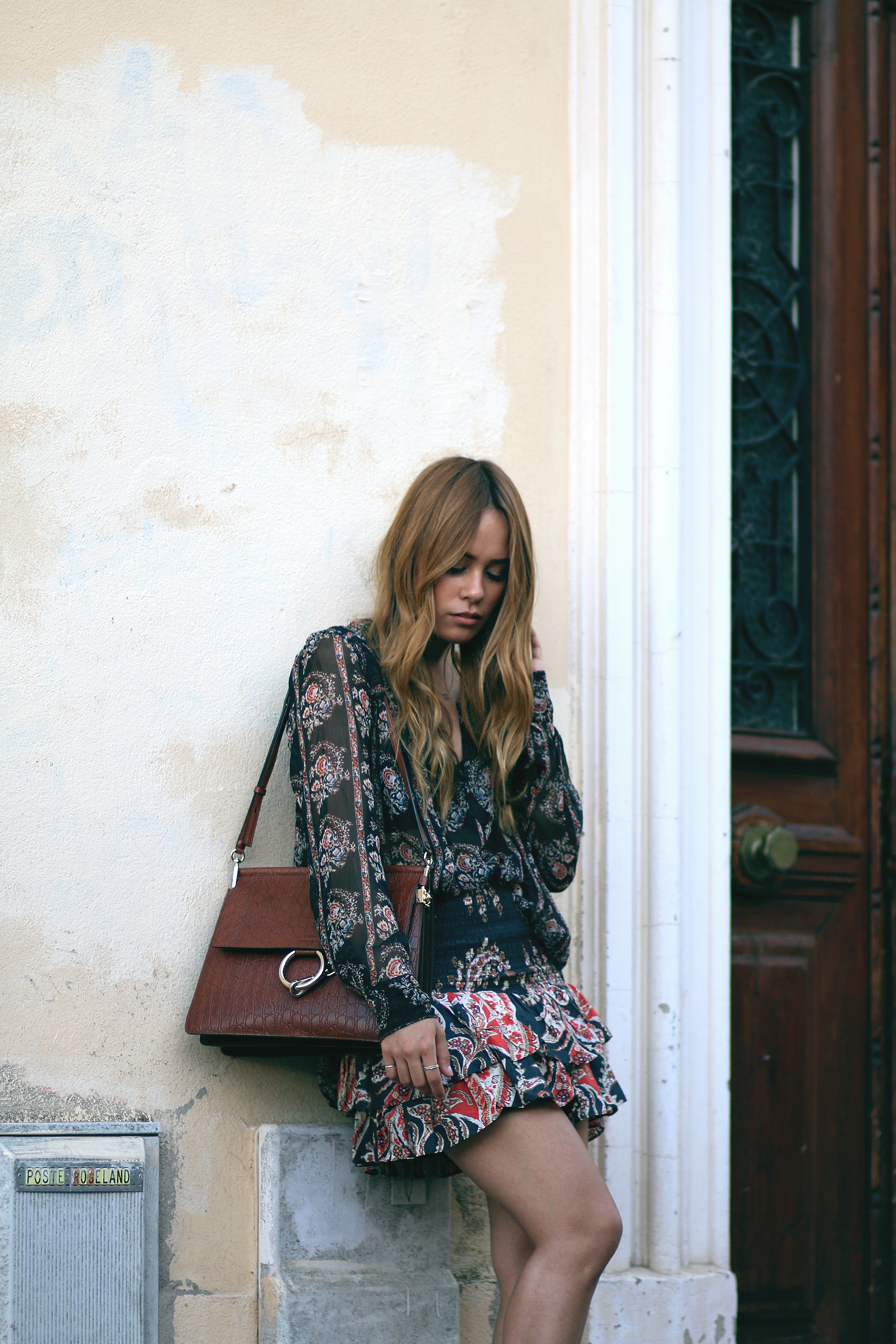 Desi is wearing: Isabel Marant printed silk blouse, Isabel Marant ruffled paisley skirt, platform sandals, Chloé Faye bag in Cannes