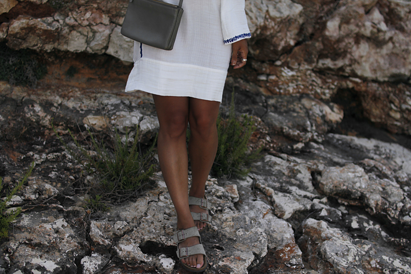 Outfit: Embroided Tunic in Cala Figuera. Desi is wearing a Céline trio bag, Arizona Brikenstock sandals, straw hat and Isabel Marant embroided tunic