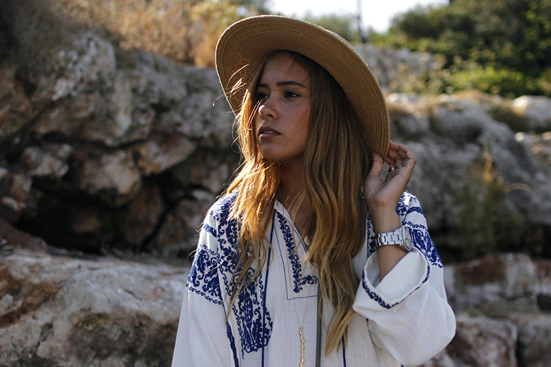 Outfit: Embroided Tunic in Cala Figuera. Desi is wearing a Céline trio bag, Arizona Brikenstock sandals, straw hat and Isabel Marant embroided tunic