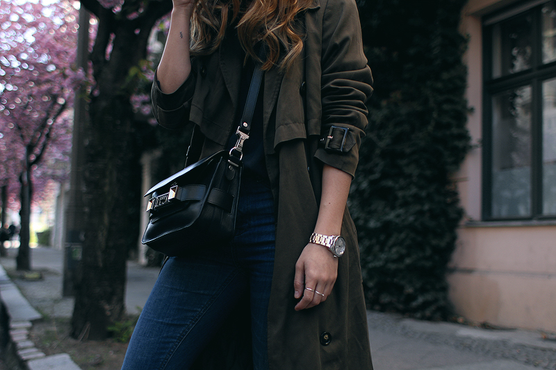 Desi is wearing: Oversized trench coat, Proenza Schouler PS11 Mini Classi bag, Isabel Marant Raelyn suede boots, navy skinny jeans, navy blouse, boyfriend watch