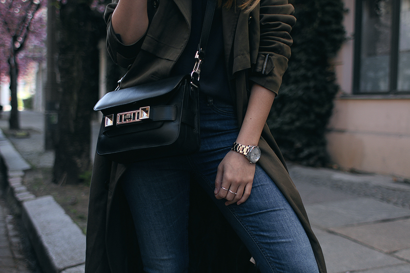 Desi is wearing: Oversized trench coat, Proenza Schouler PS11 Mini Classi bag, Isabel Marant Raelyn suede boots, navy skinny jeans, navy blouse, boyfriend watch