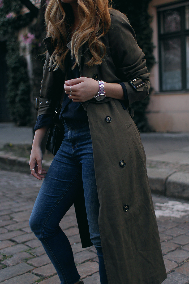 Desi is wearing: Oversized trench coat, Proenza Schouler PS11 Mini Classi bag, Isabel Marant Raelyn suede boots, navy skinny jeans, navy blouse, boyfriend watch