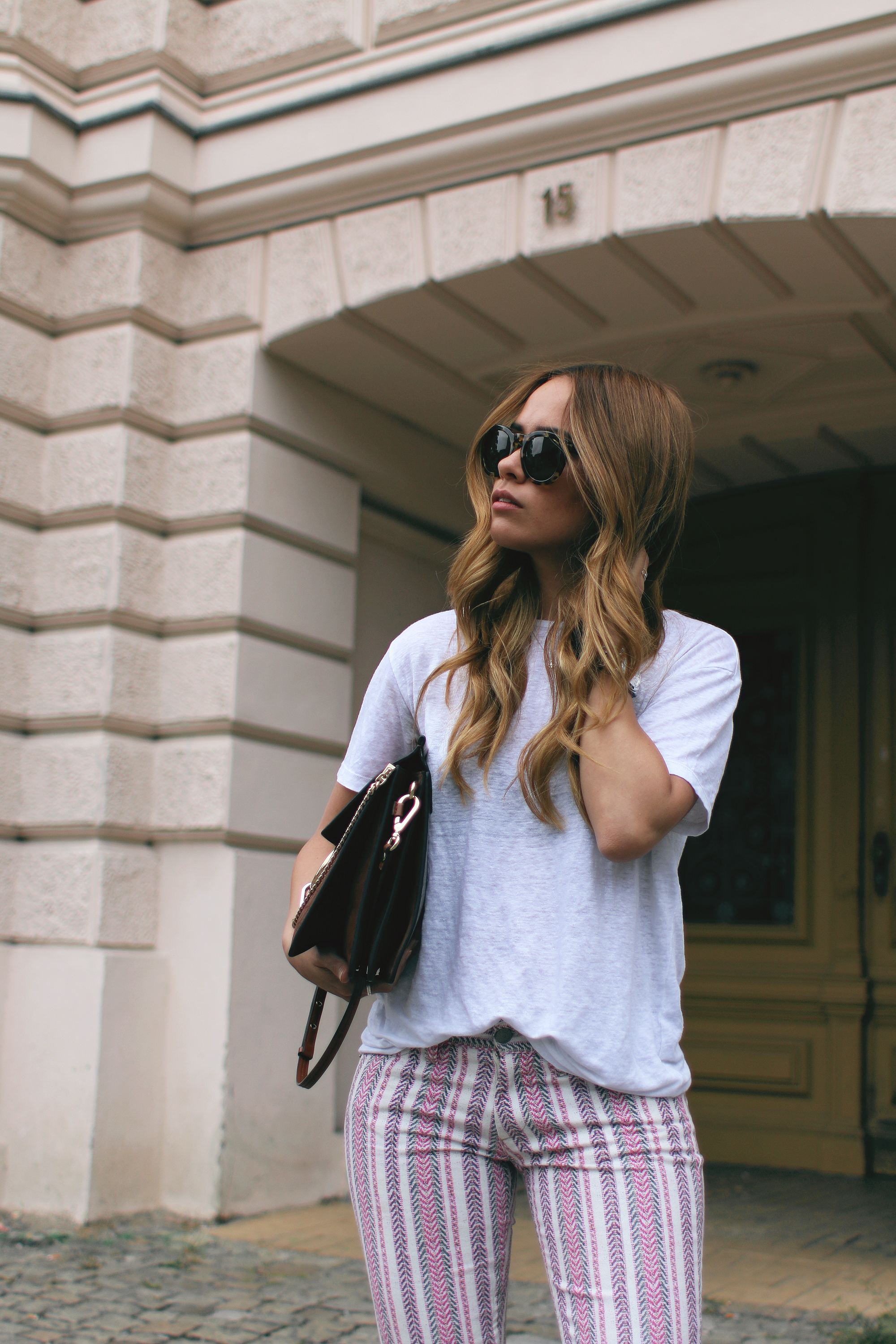 Desi wearing: Isabel Marant Étoile Printed trousers, Hermès Oran sandals, Chloé Faye bag, Céline Sunglasses, white linen shirt, boyfriend watch